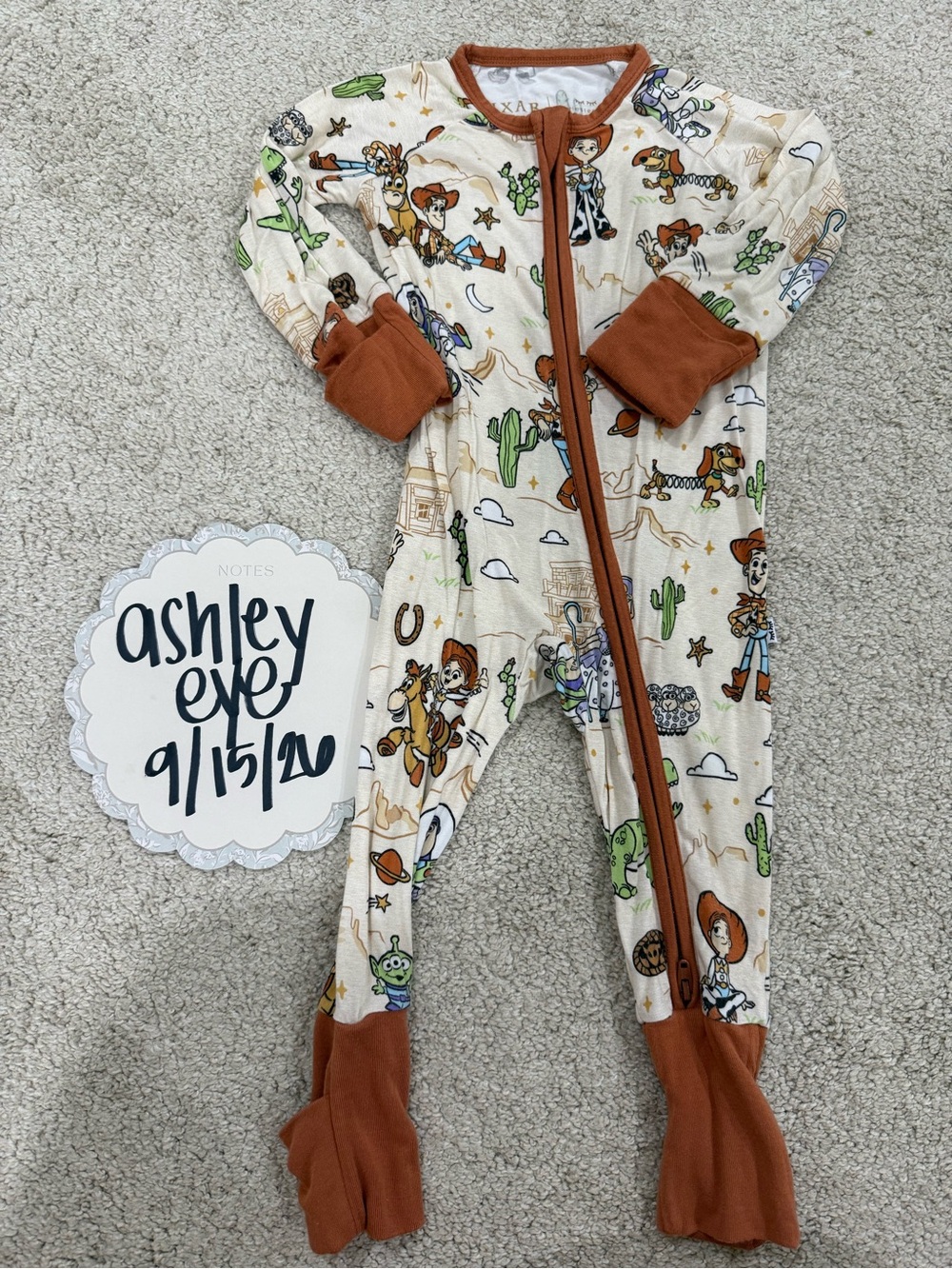 Little Sleepies Cream Toy Story Footed One-Piece Pajamas with Brown Trim